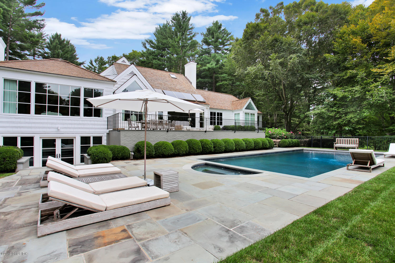 a view of house with swimming pool and chairs