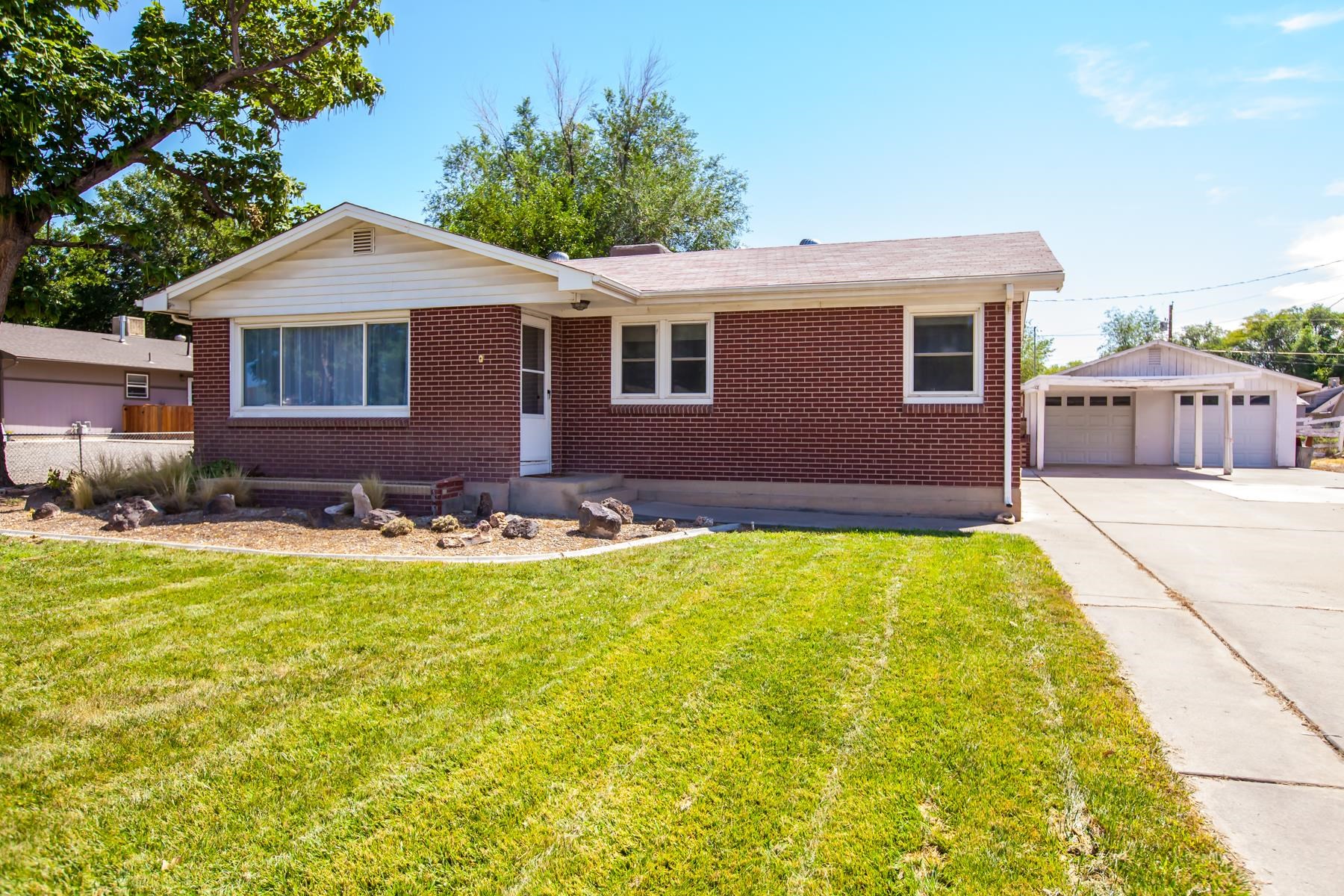 a view of house with yard and outdoor seating