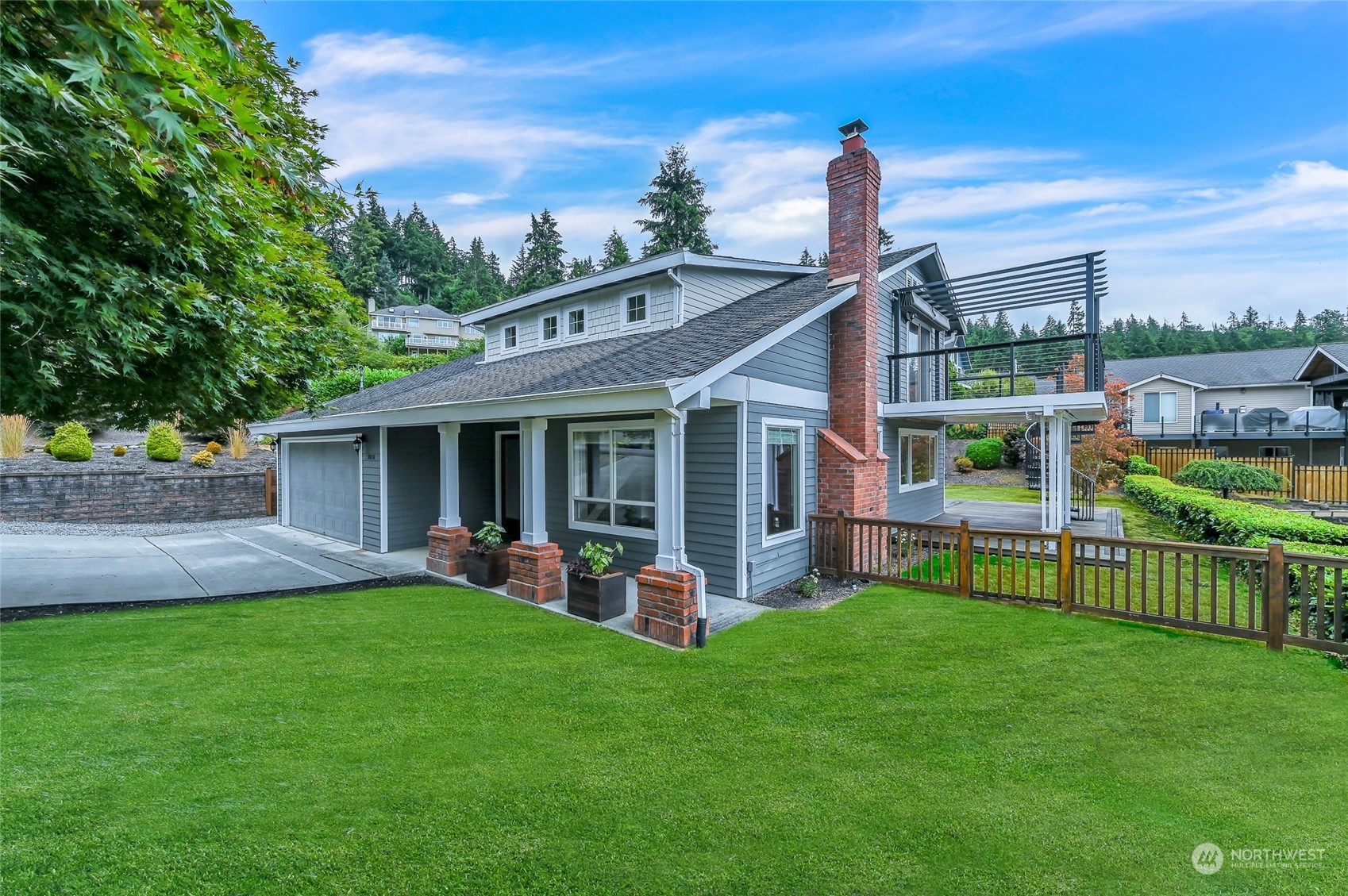 a front view of a house with a garden and yard