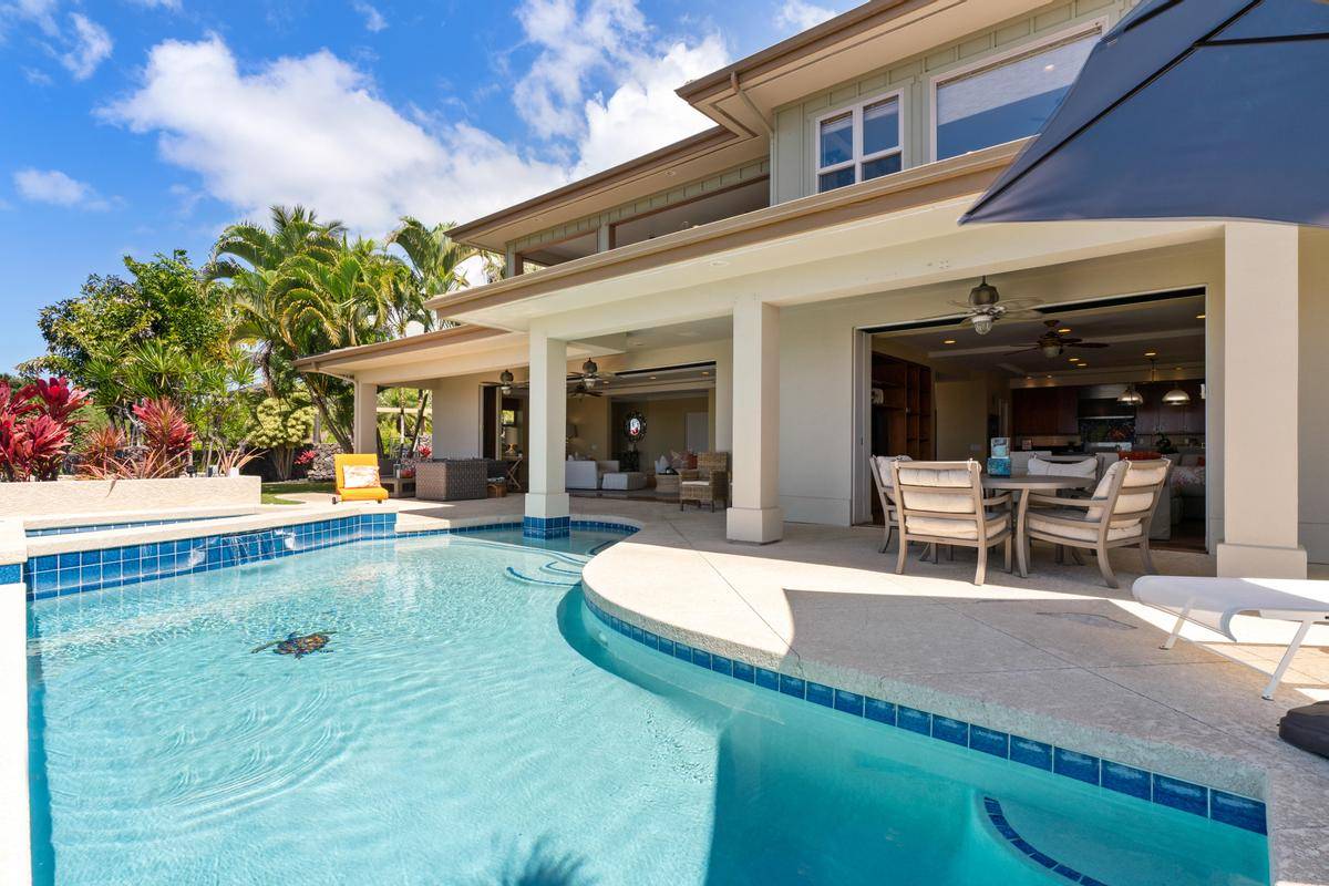 a swimming pool with outdoor seating and yard