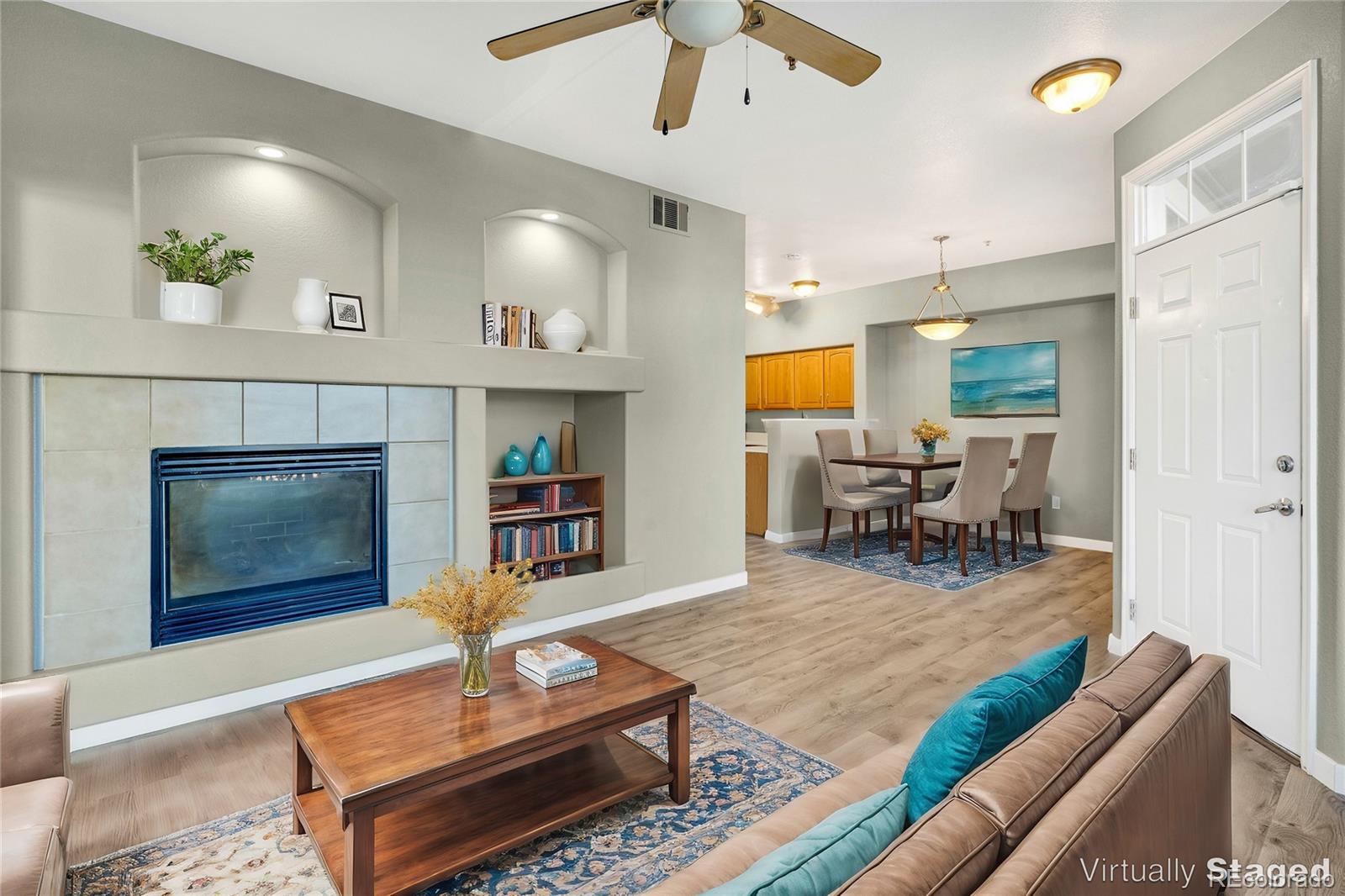 a living room with furniture and a fireplace