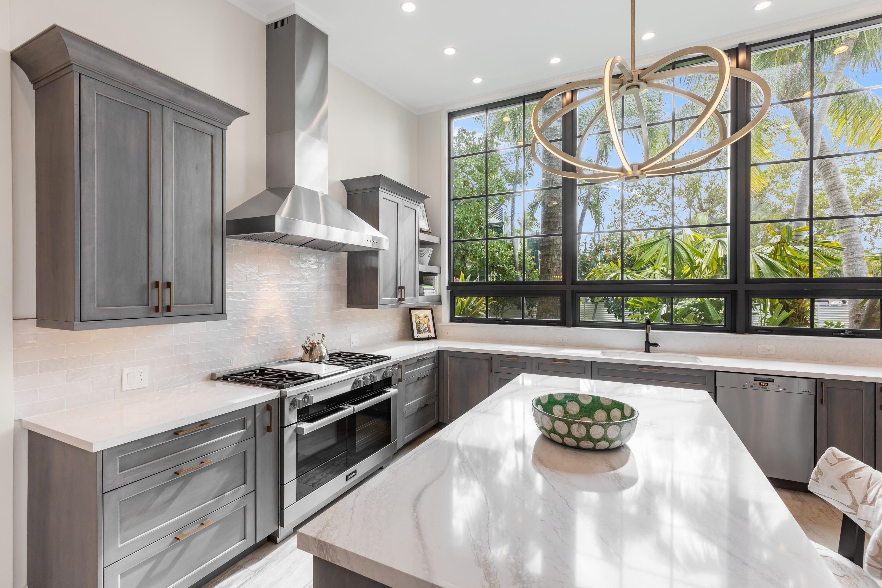 a kitchen with stainless steel appliances a sink a stove and a wooden floors