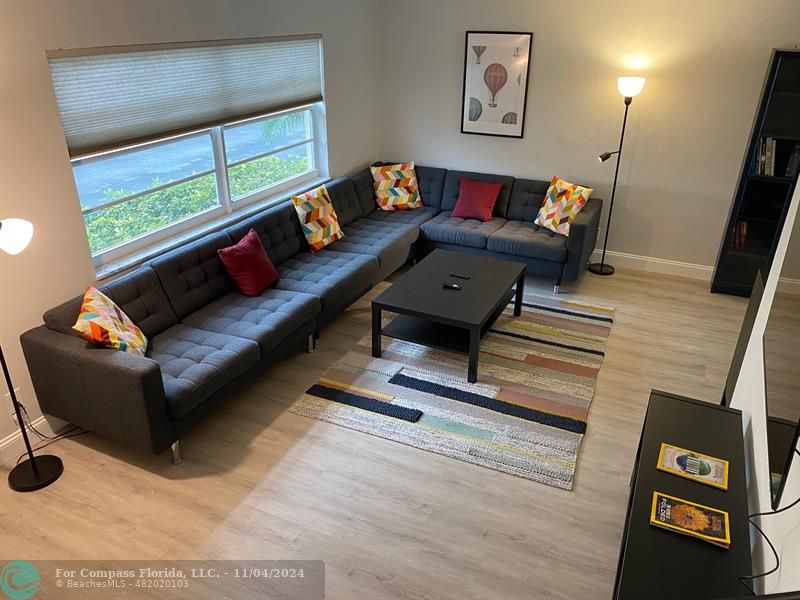 a living room with furniture and a window