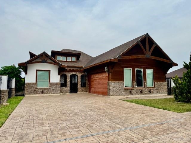 a front view of a house with yard and garage