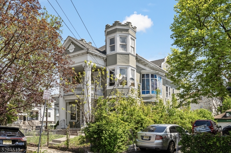 a front view of a residential apartment building with a yard