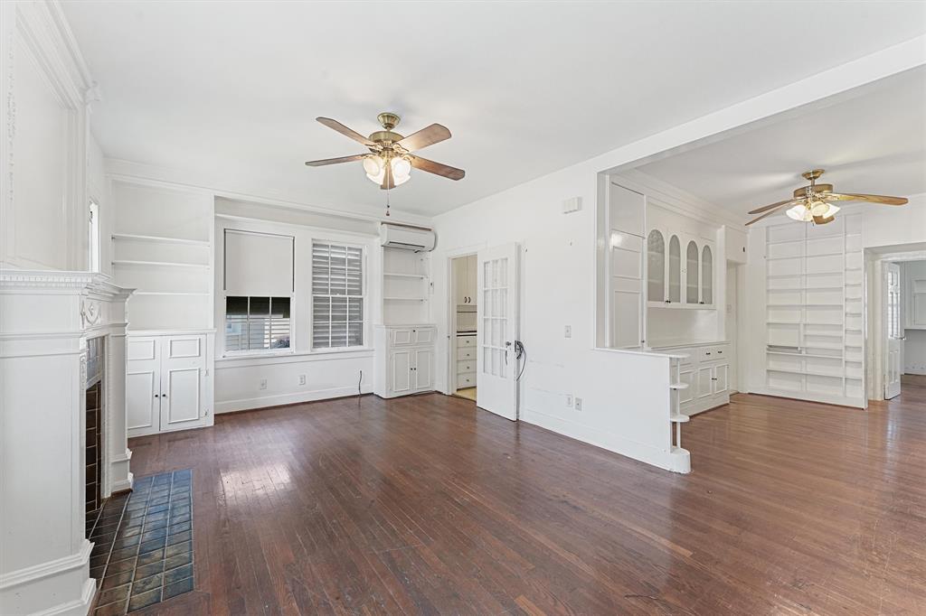 a view of empty room with wooden floor and window