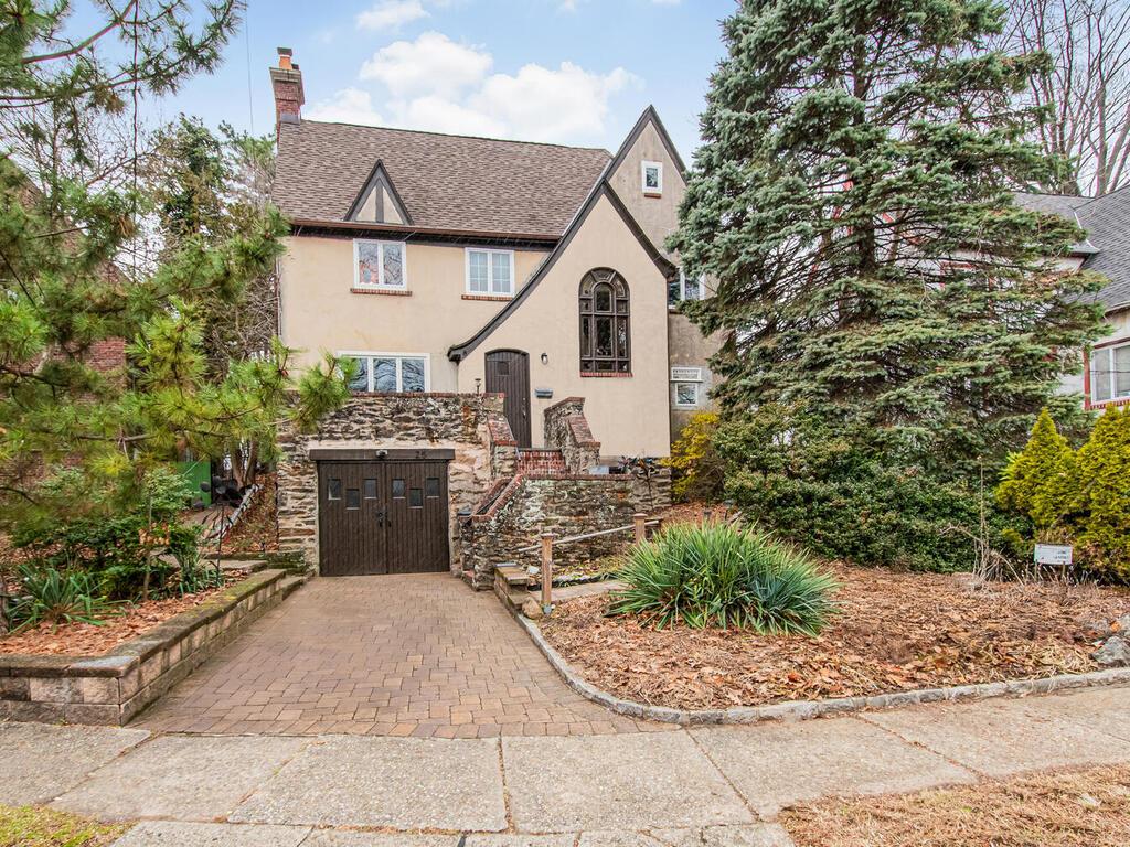 Tudor-style house with a garage.