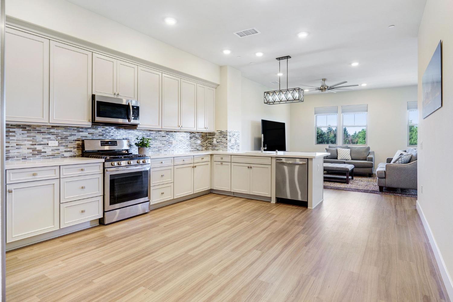 a kitchen with a white cabinets and window