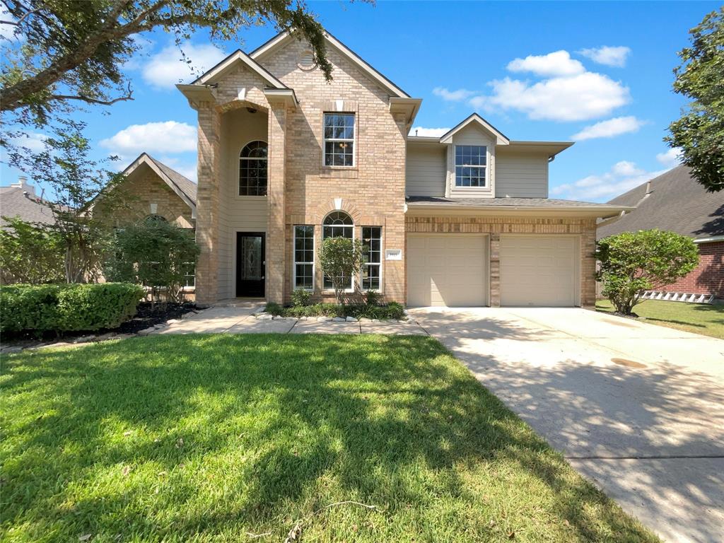 a front view of a house with a yard