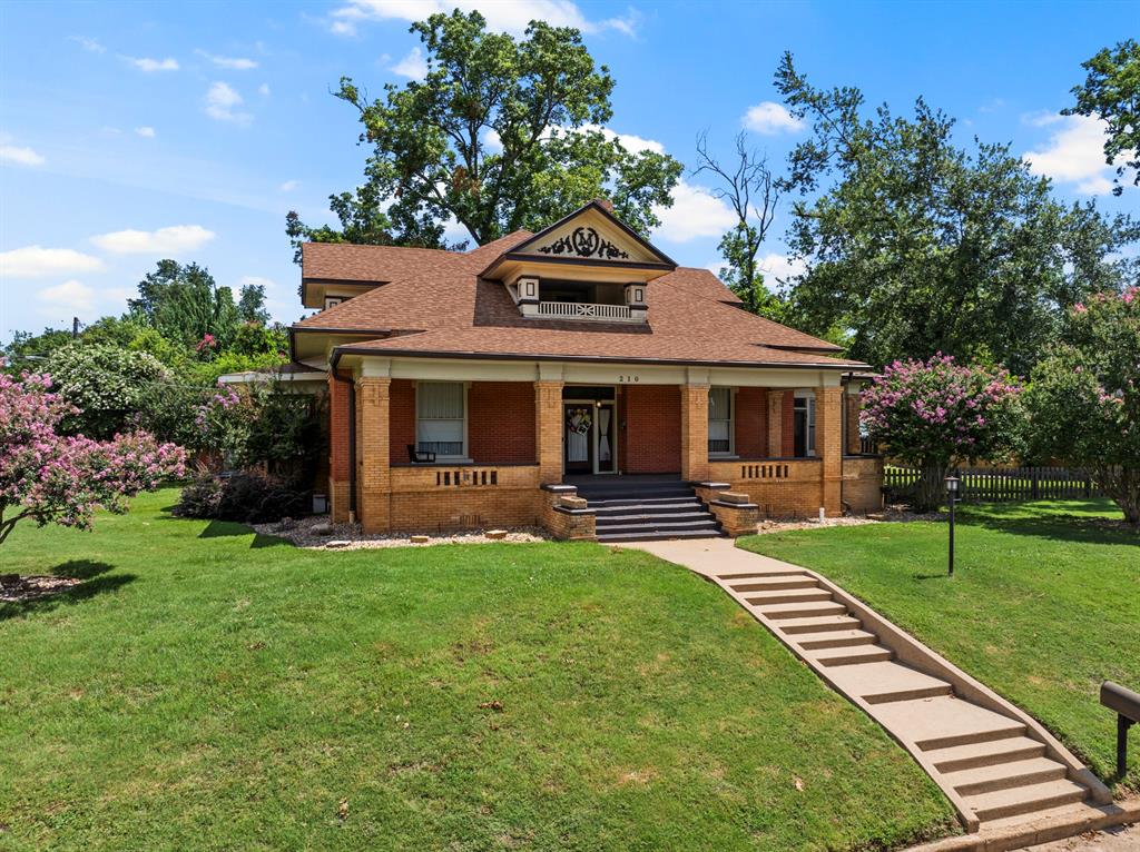 a front view of a house with a yard porch and outdoor seating