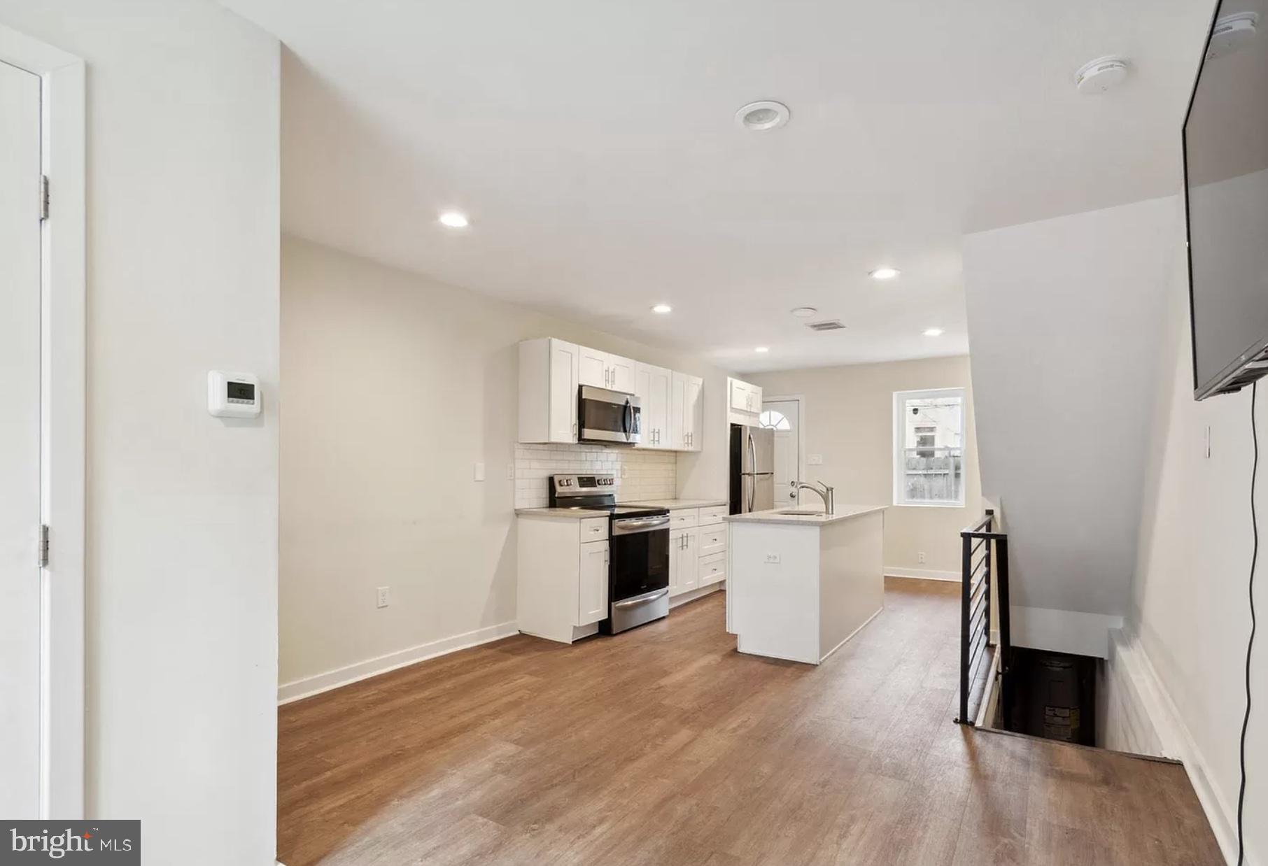 a kitchen with a sink and a refrigerator