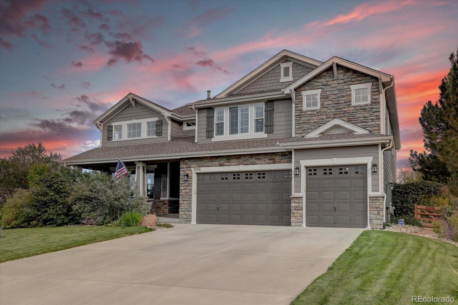 a front view of a house with a garden and garage