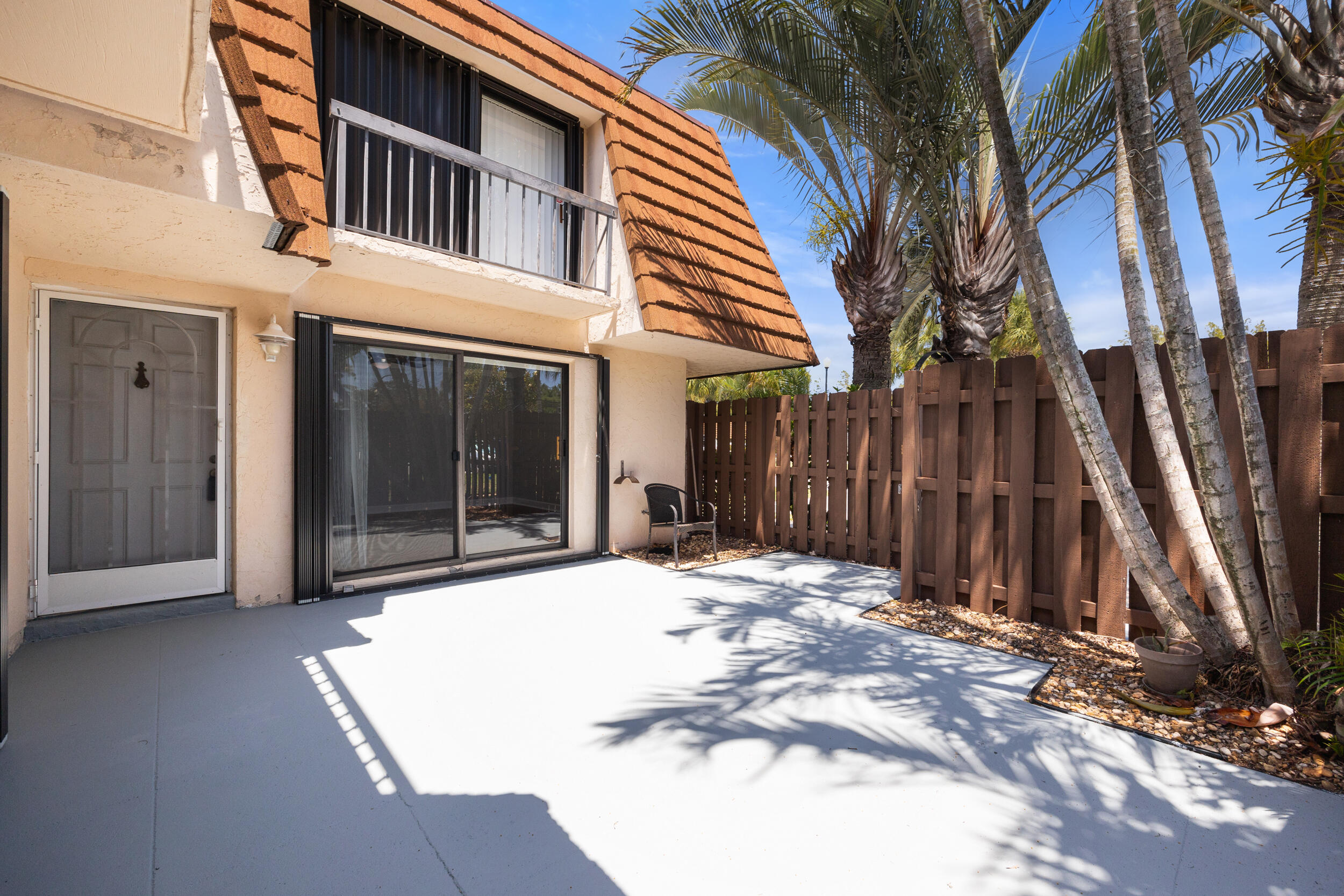 a view of a house with a wooden fence