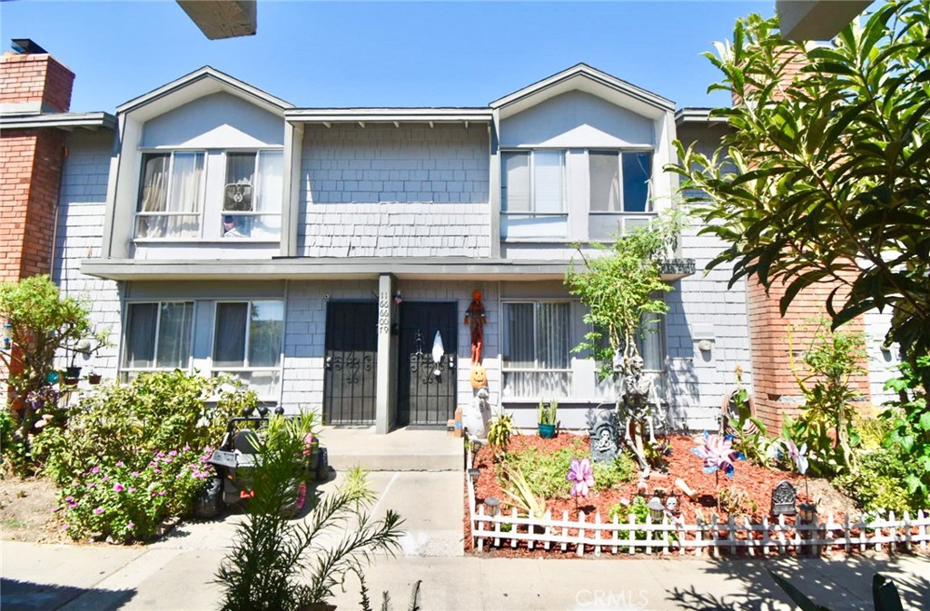 a front view of a house with a garden