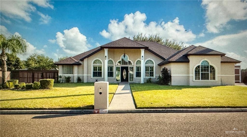 a view of a house with swimming pool and a yard