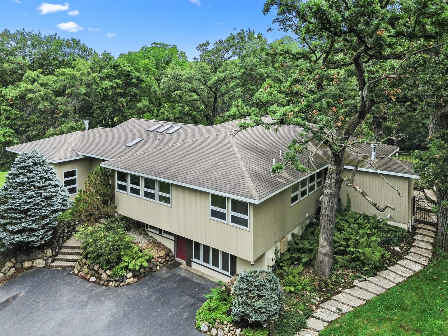 an aerial view of a house with a yard and potted plants