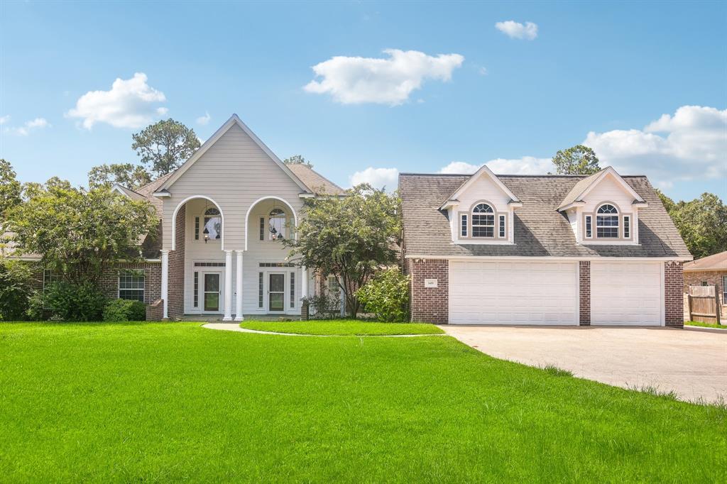 a front view of a house with a garden and yard