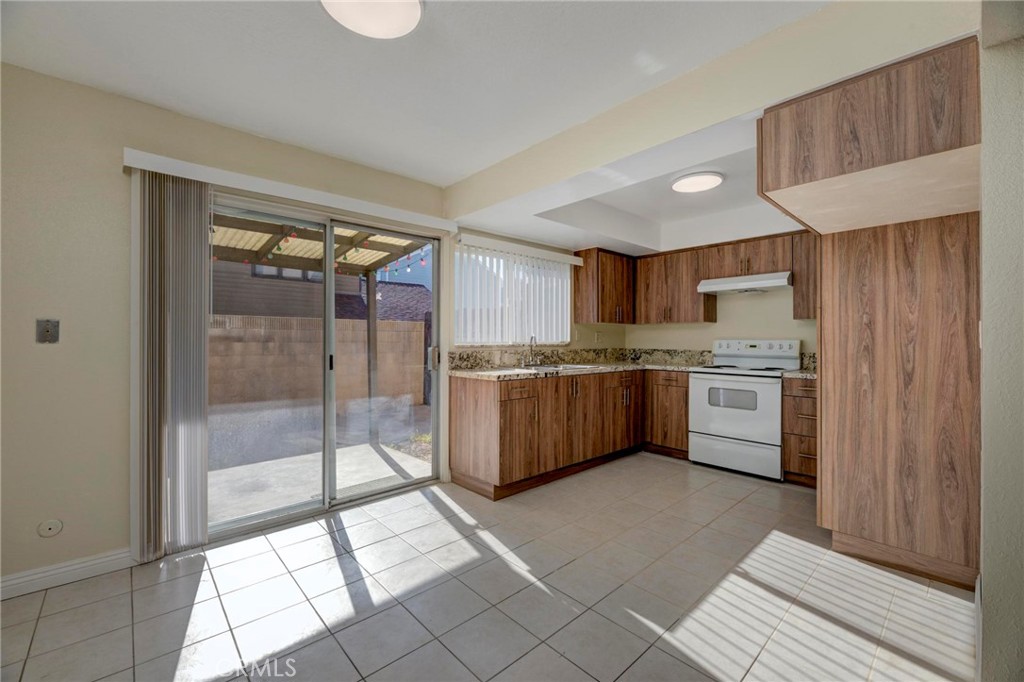 a kitchen with stainless steel appliances a sink and a refrigerator