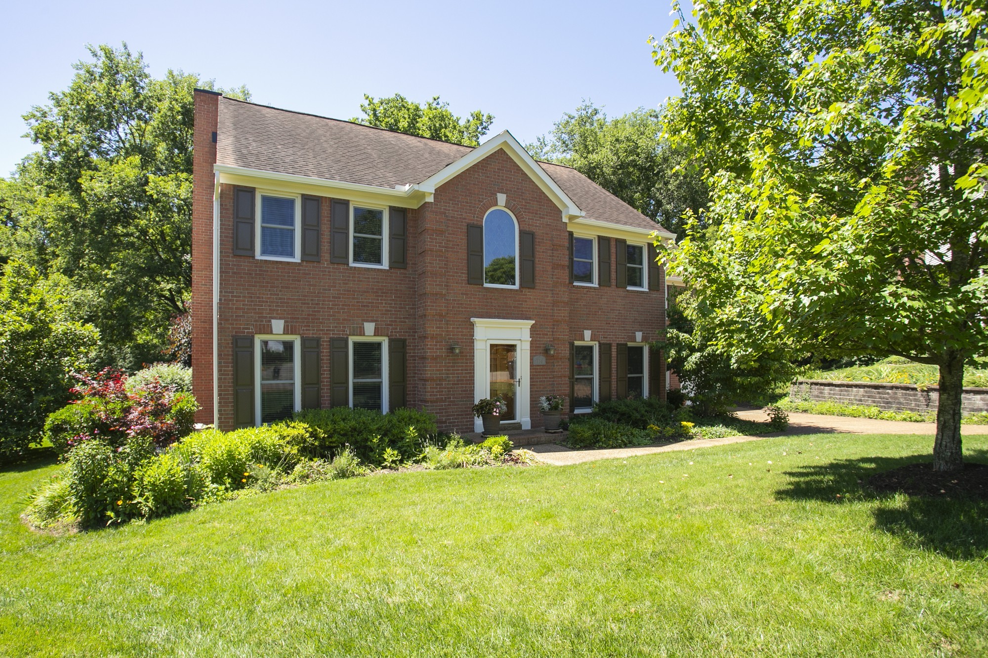 a front view of house with yard and green space