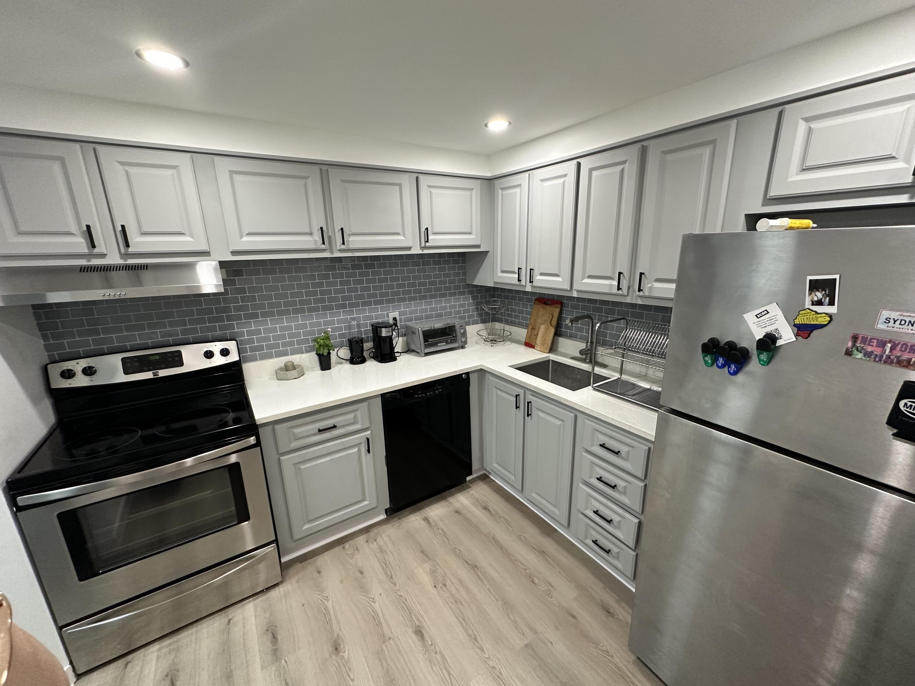 a kitchen with a sink stove and cabinets