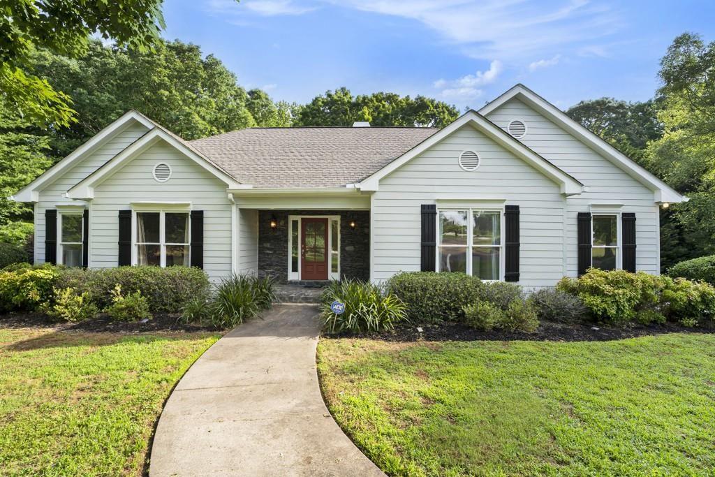 a front view of a house with garden