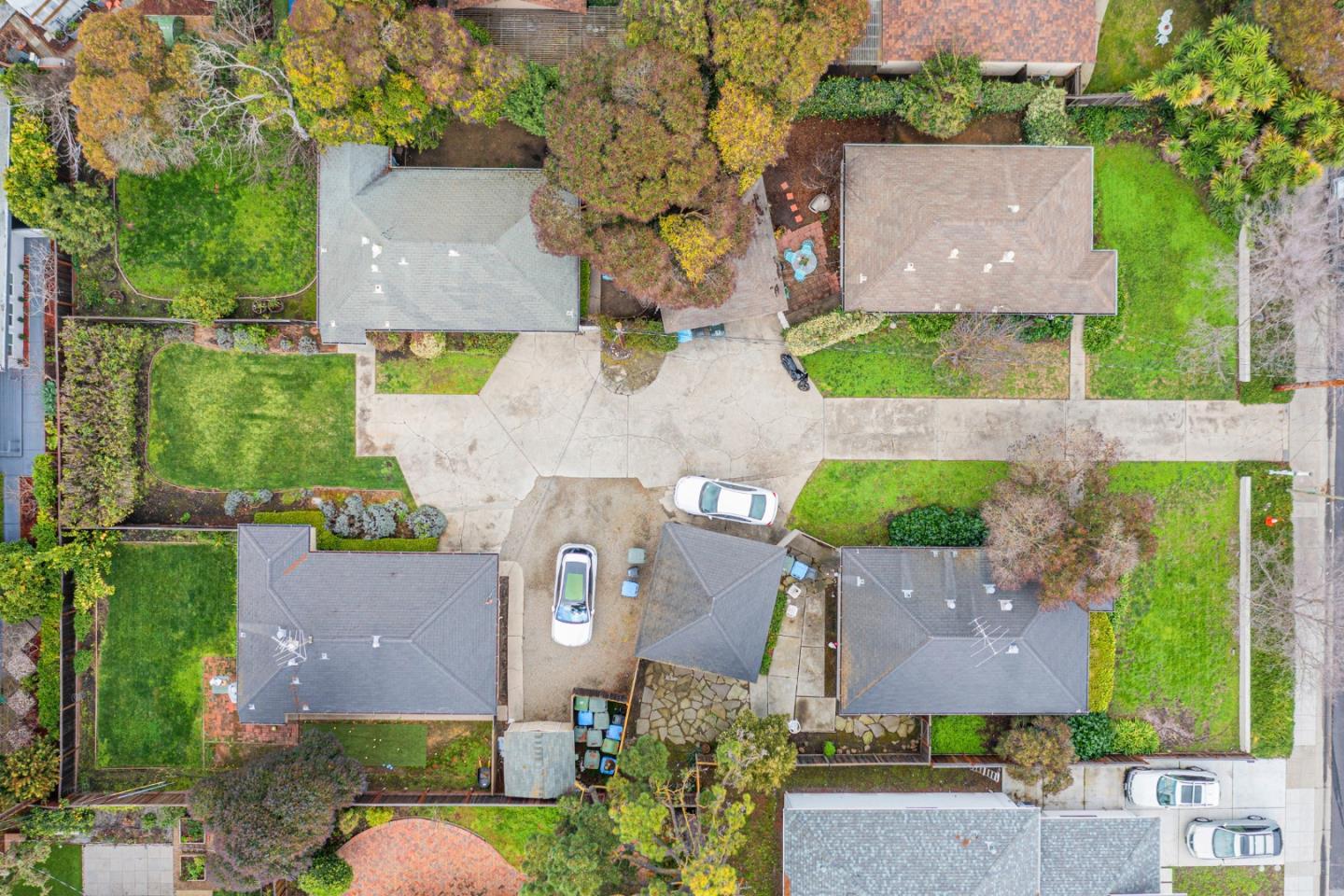 an aerial view of residential houses with outdoor space and street view