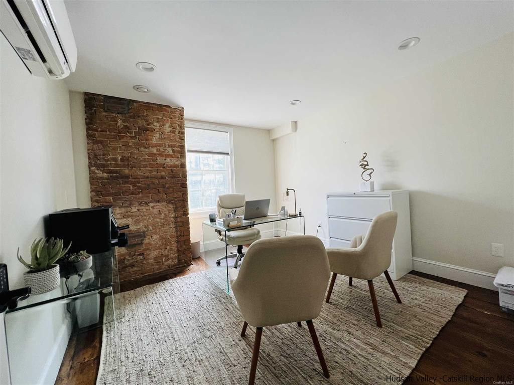 a workspace with furniture window and wooden floor