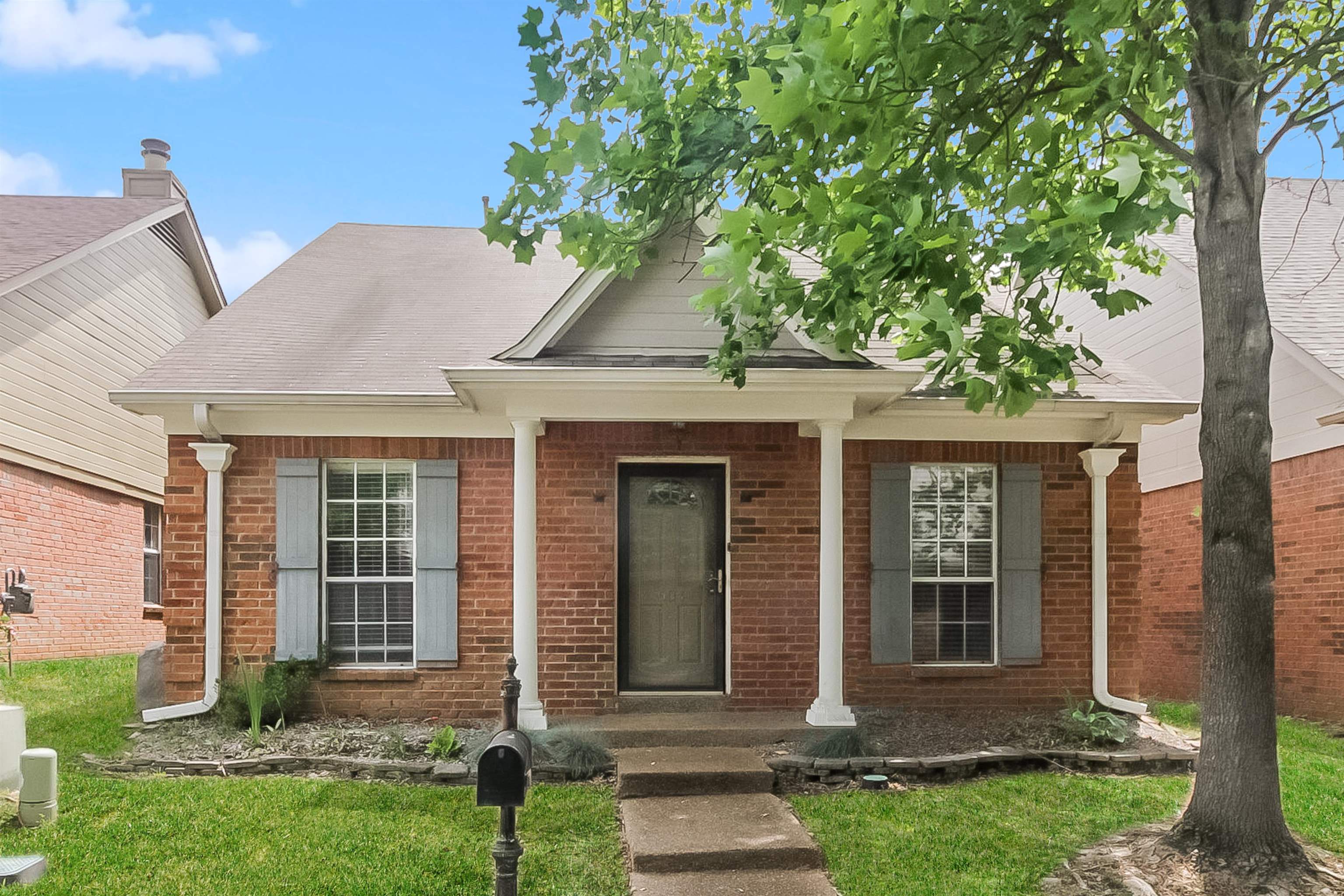 front view of a house with a yard