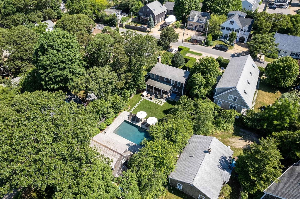 an aerial view of a house with a yard and lake view