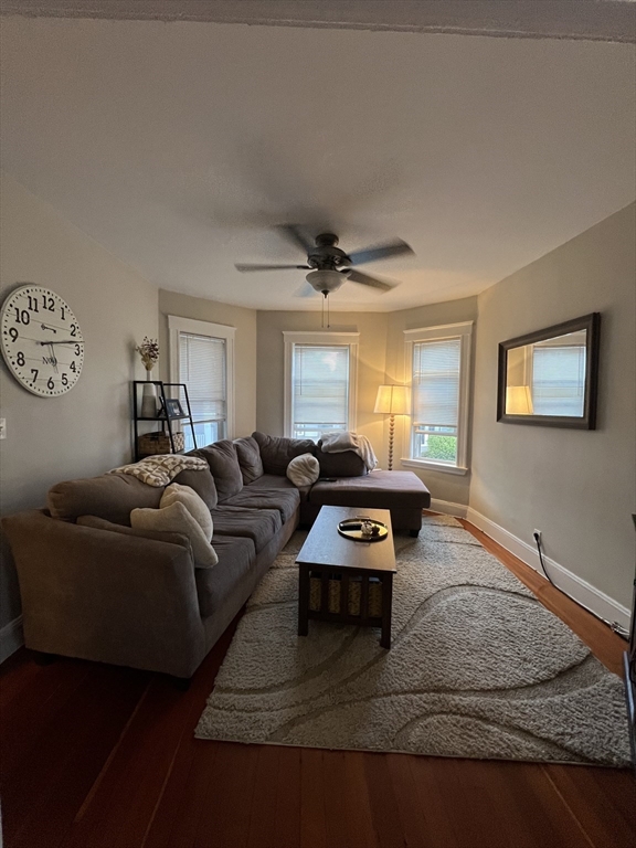 a living room with furniture a rug and a window