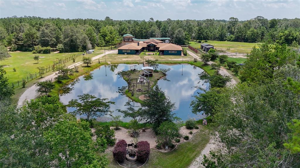 an aerial view of a house with yard swimming pool and outdoor seating