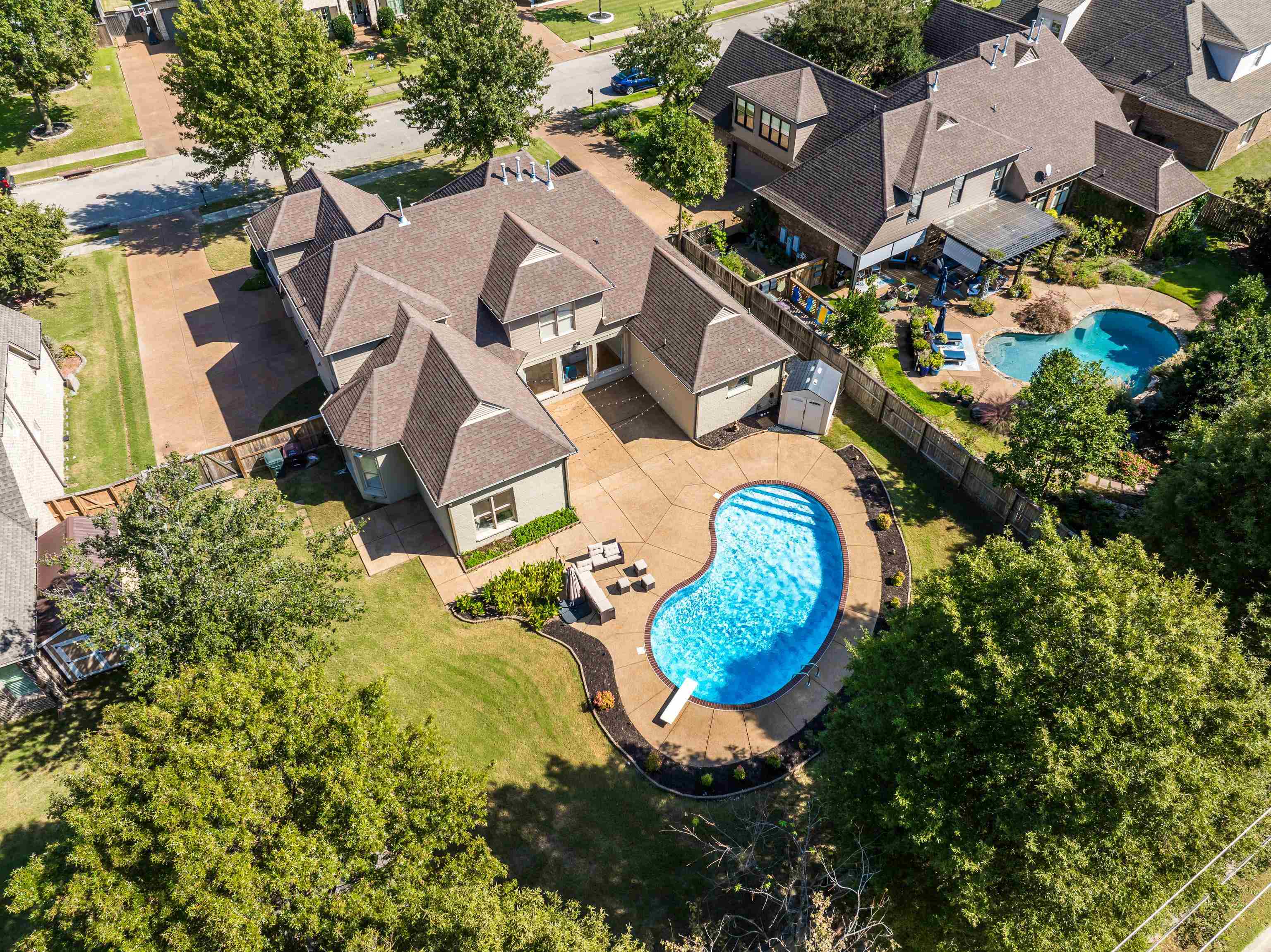 an aerial view of a house with a swimming pool and outdoor space