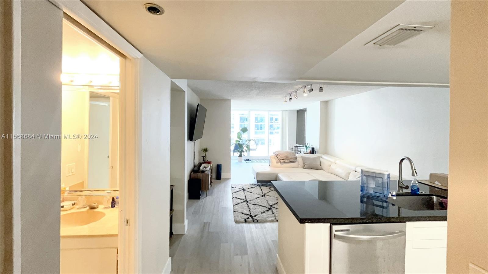 a kitchen with a refrigerator and a sink