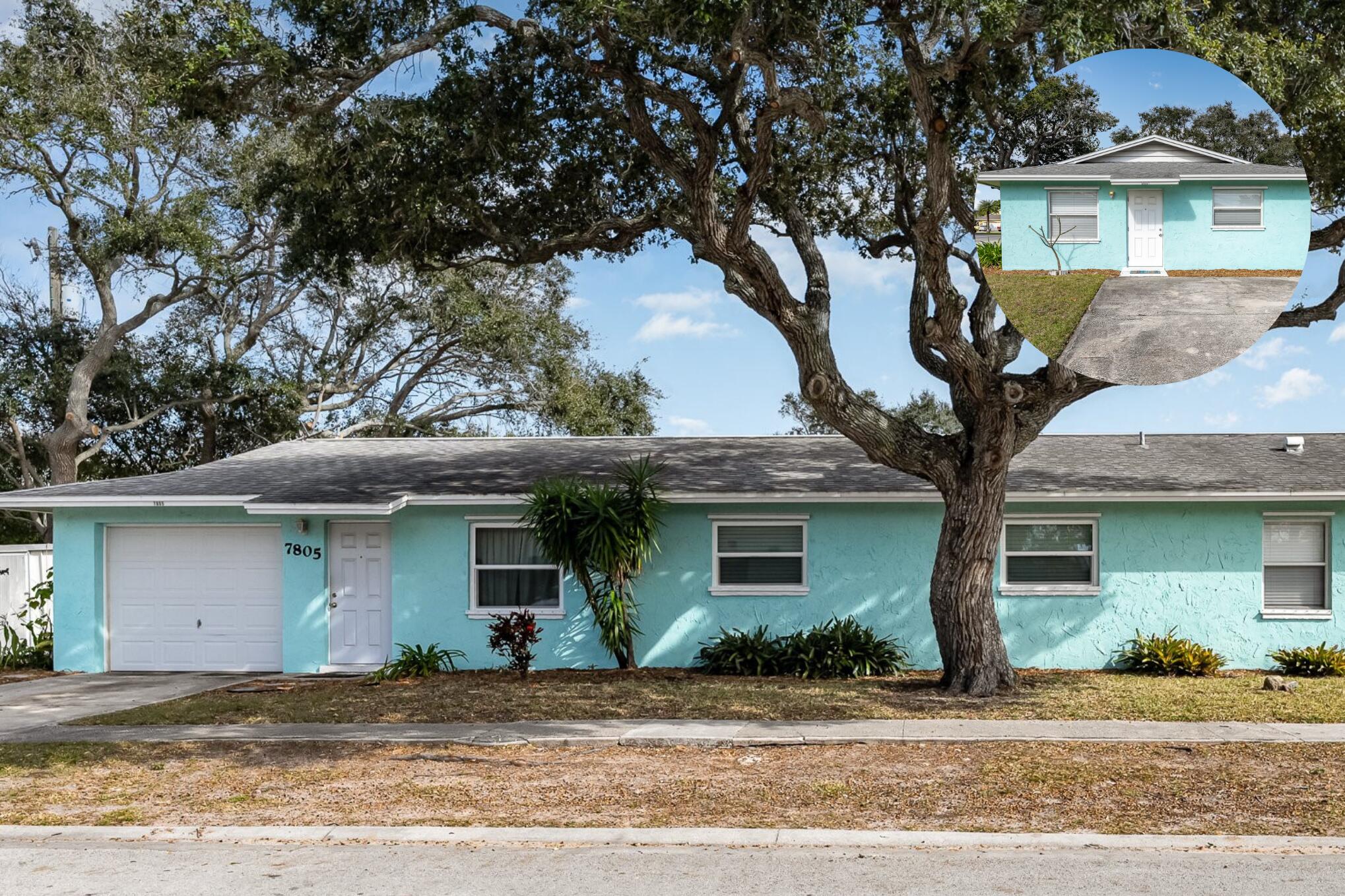 a front view of a house with a tree