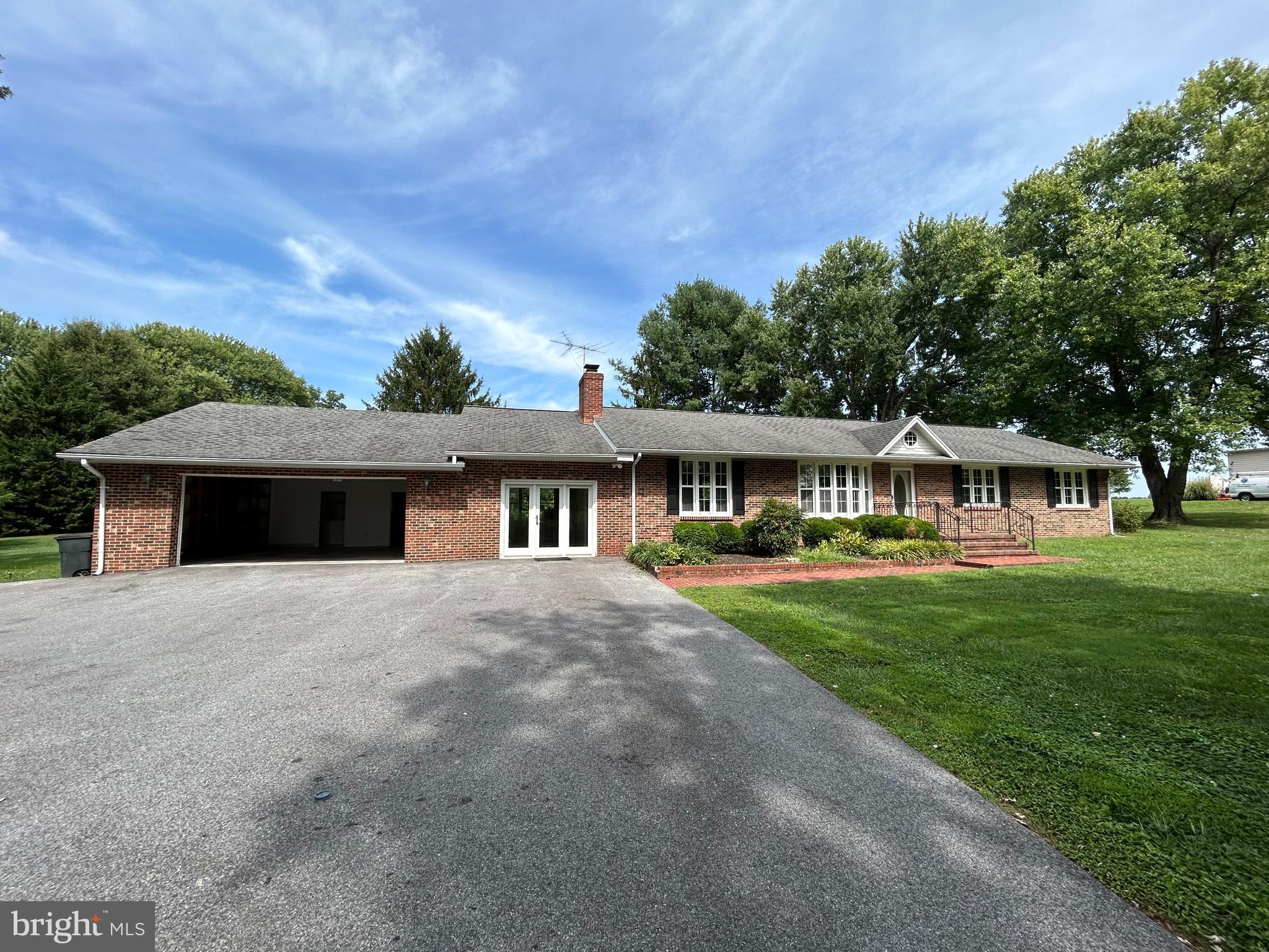 a front view of a house with yard and green space