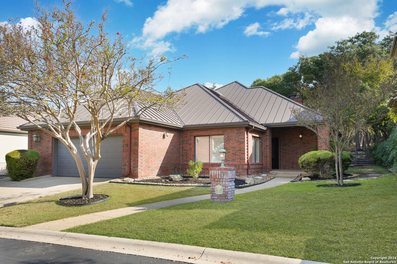 a front view of house with yard and green space