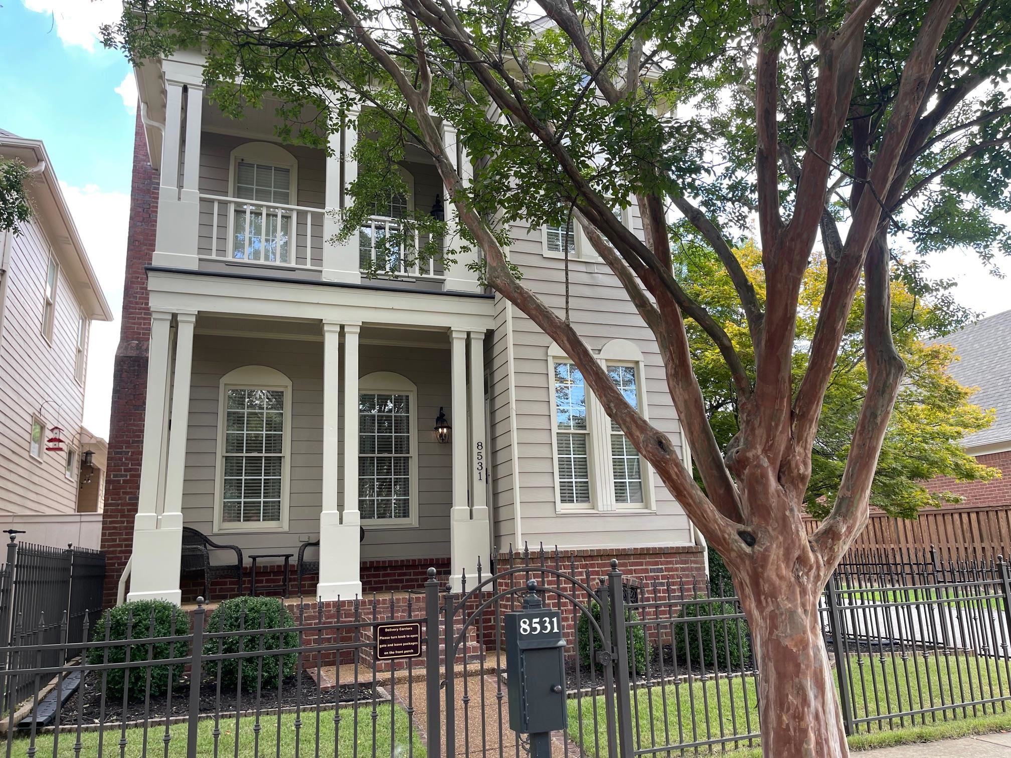 front view of a house with a tree