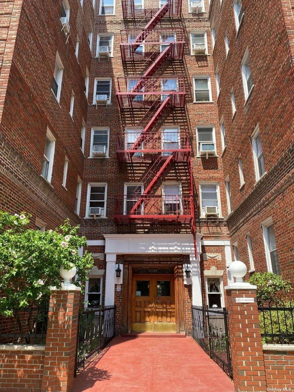 a view of a building with a small yard