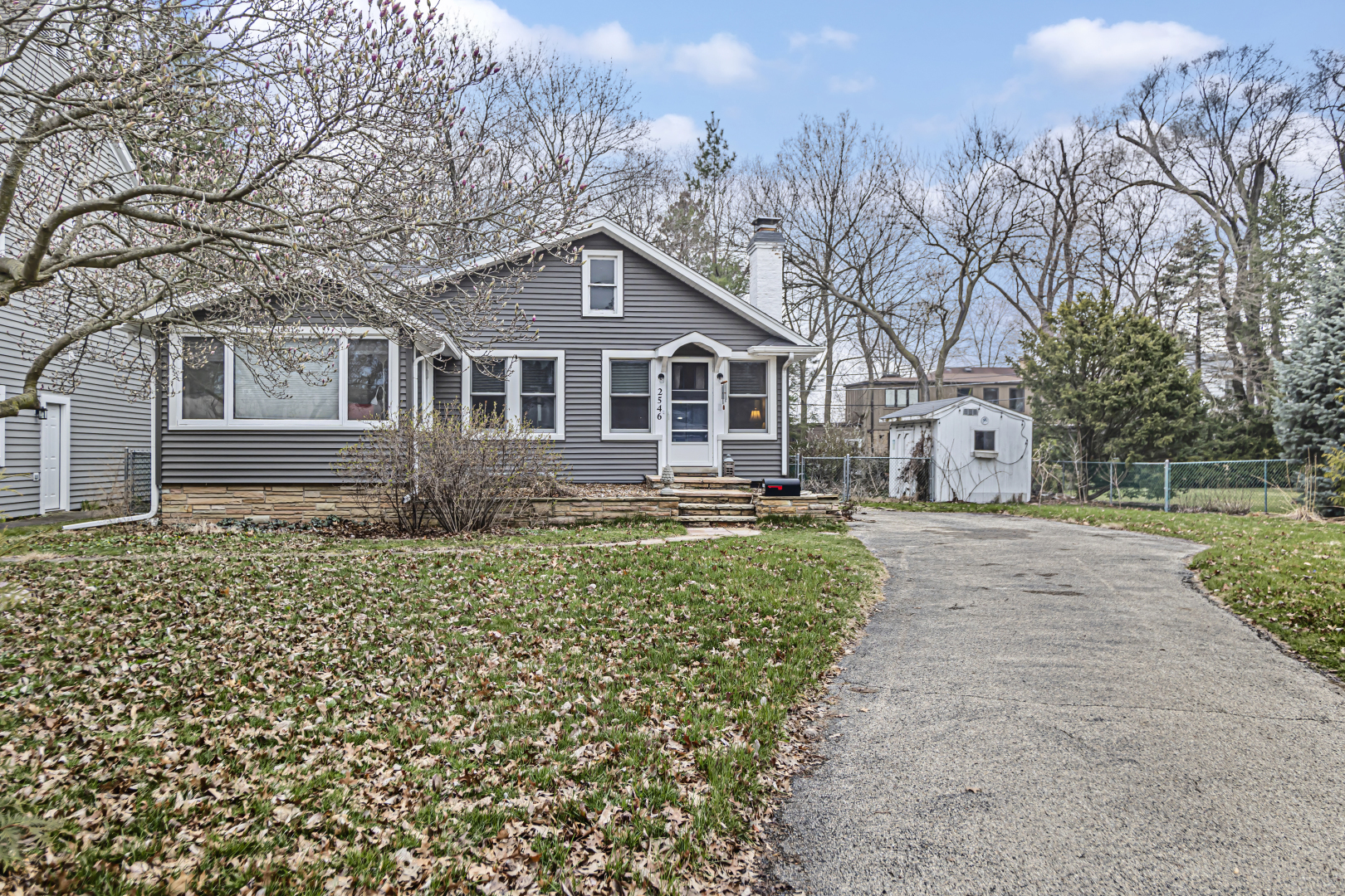 a front view of a house with a garden