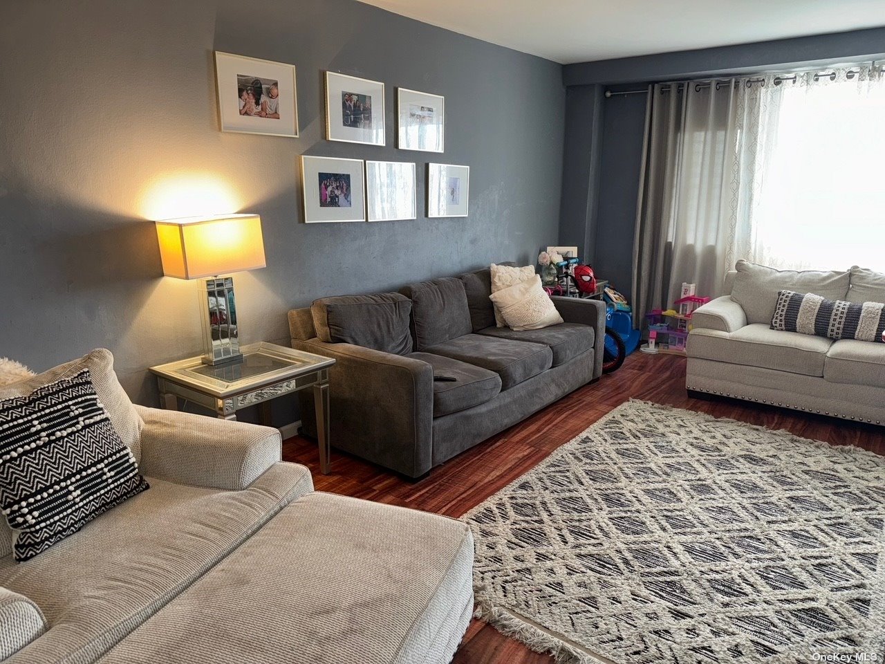 a living room with furniture and a lamp