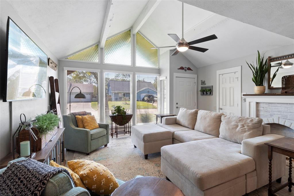 a living room with furniture a chandelier and a fireplace