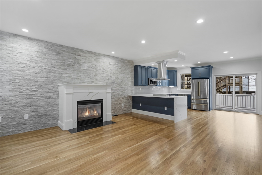 a large kitchen with cabinets and a fireplace