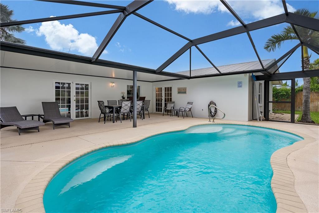 a swimming pool with outdoor seating and yard