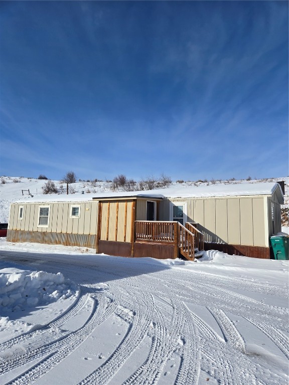 View of front of house with a wooden deck