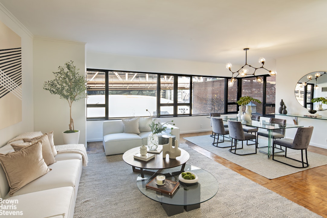 a living room with furniture and a chandelier