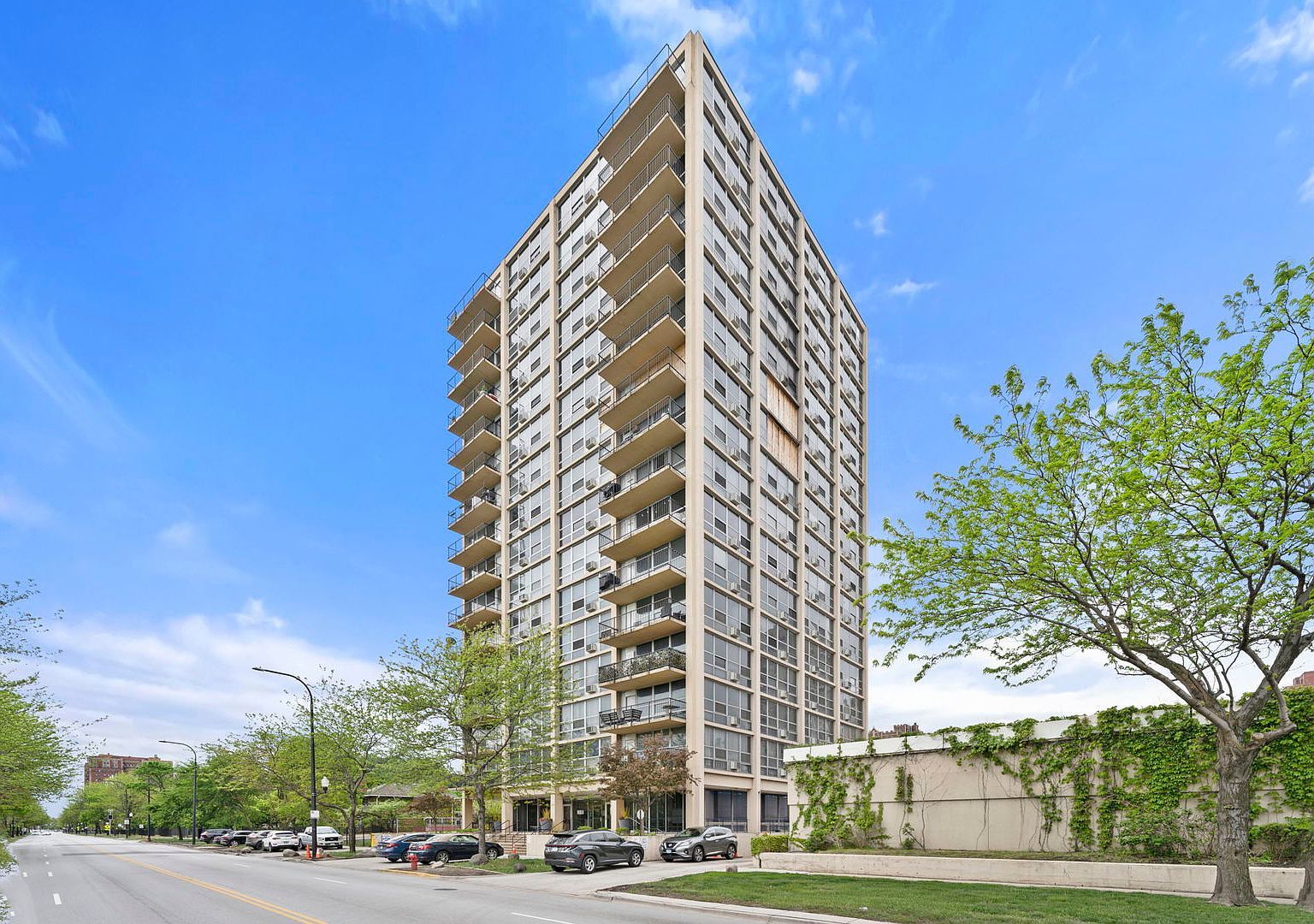 a view of a tall building next to a road