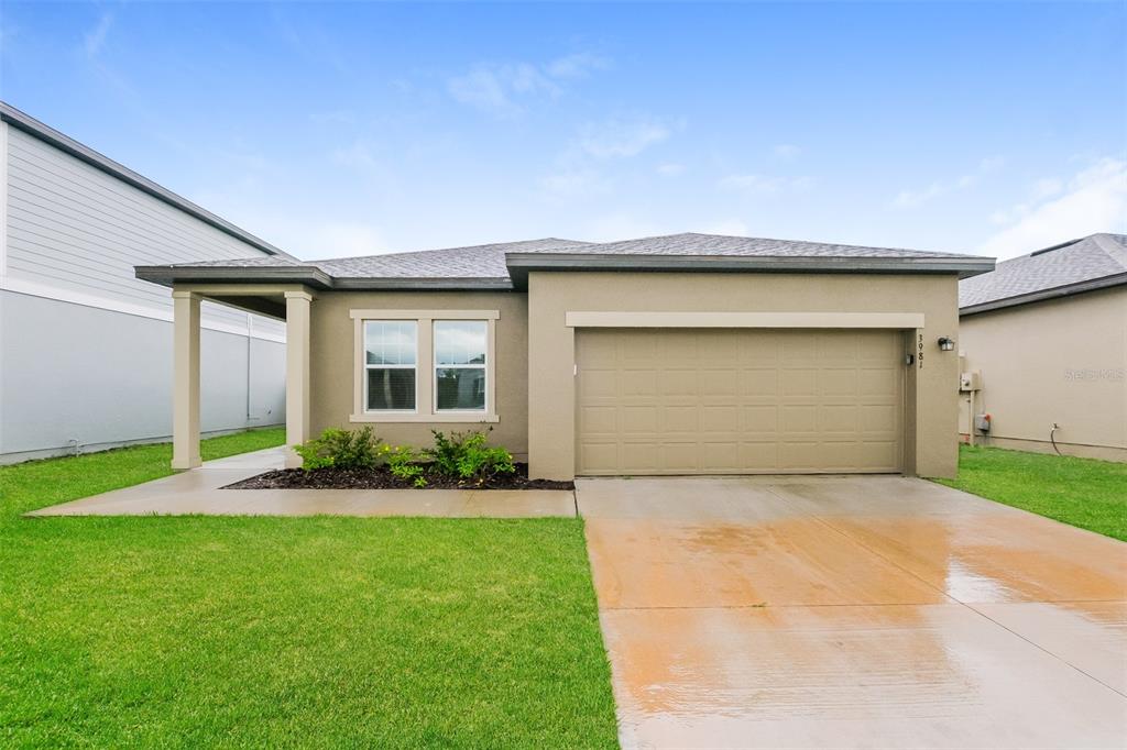 a front view of a house with a yard and garage