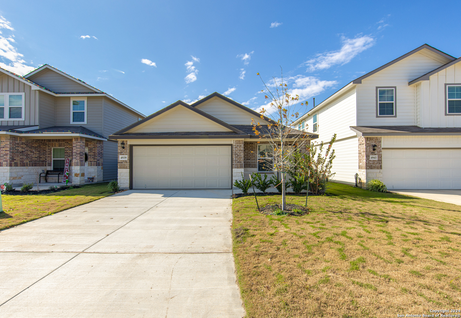 a front view of a house with a garden