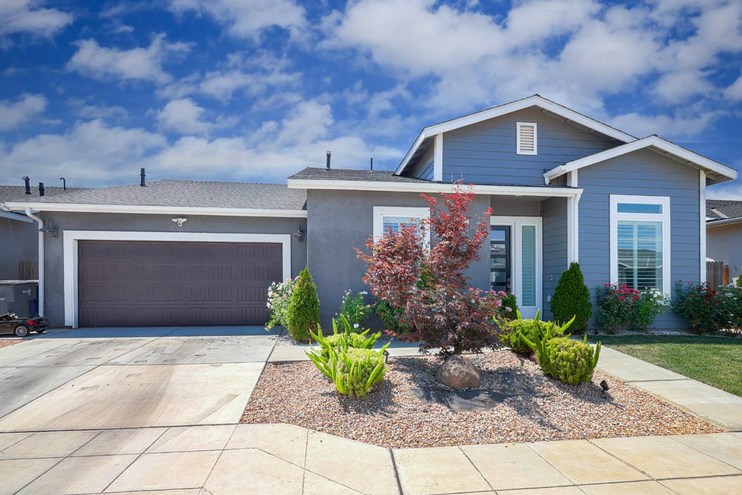 a front view of a house with garden