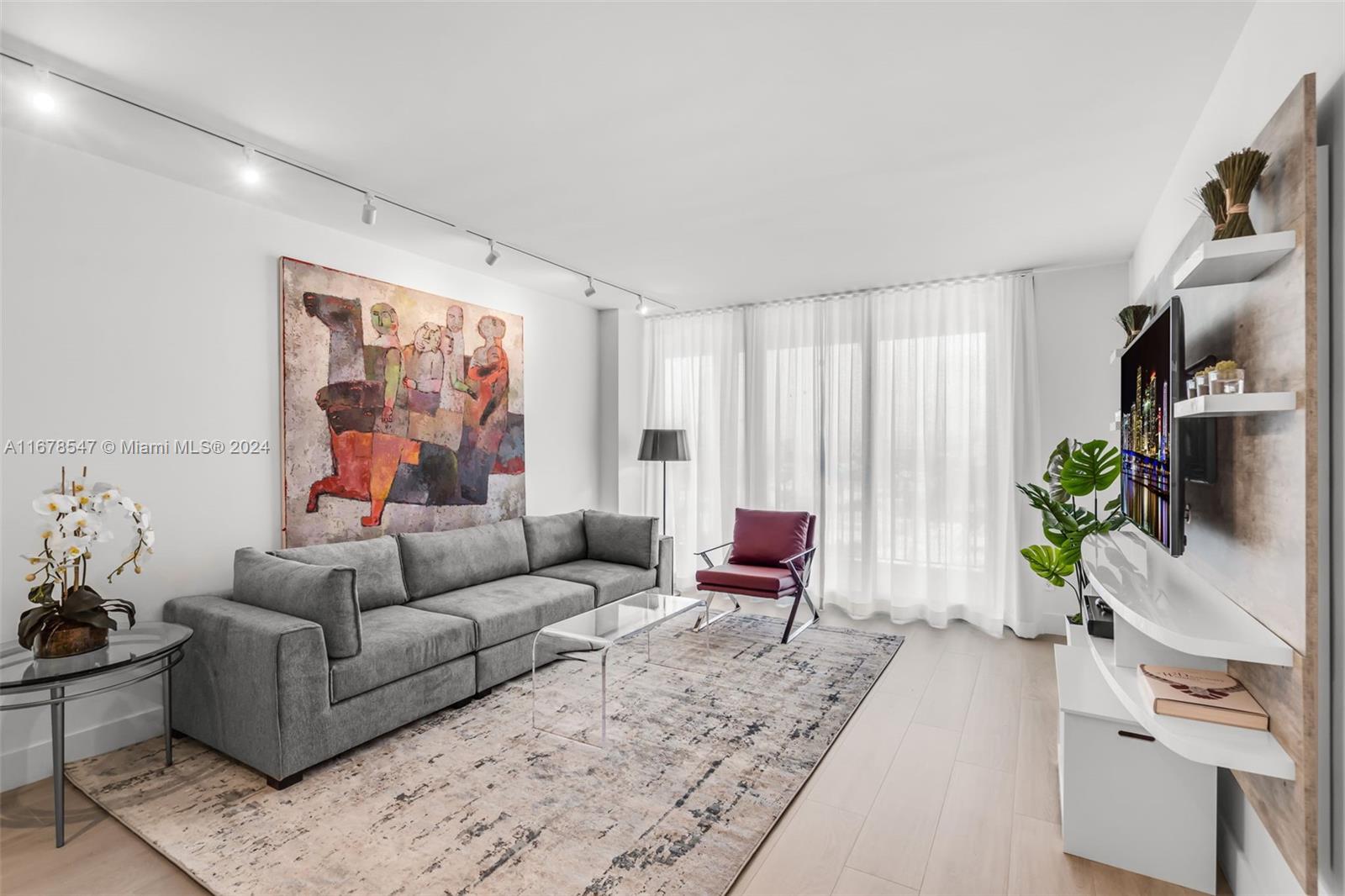 a living room with furniture and a potted plant